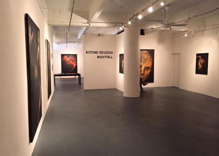 Photo of the gallery from inside with artwork on display.